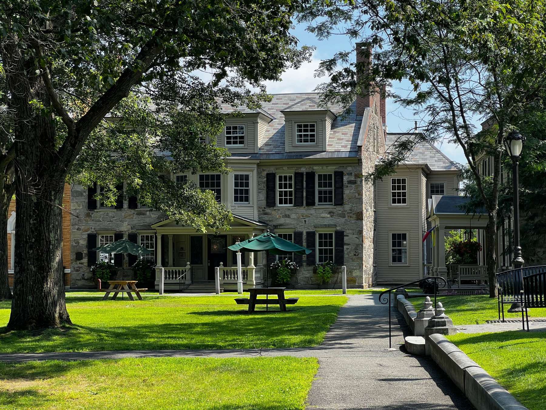 Stone colonial house and lawn on a New England town green